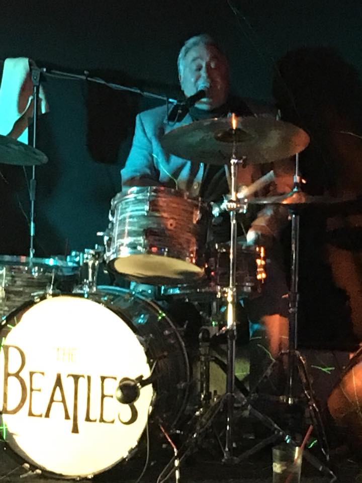 Boots & Suits bassist with a violin bass under stage lights