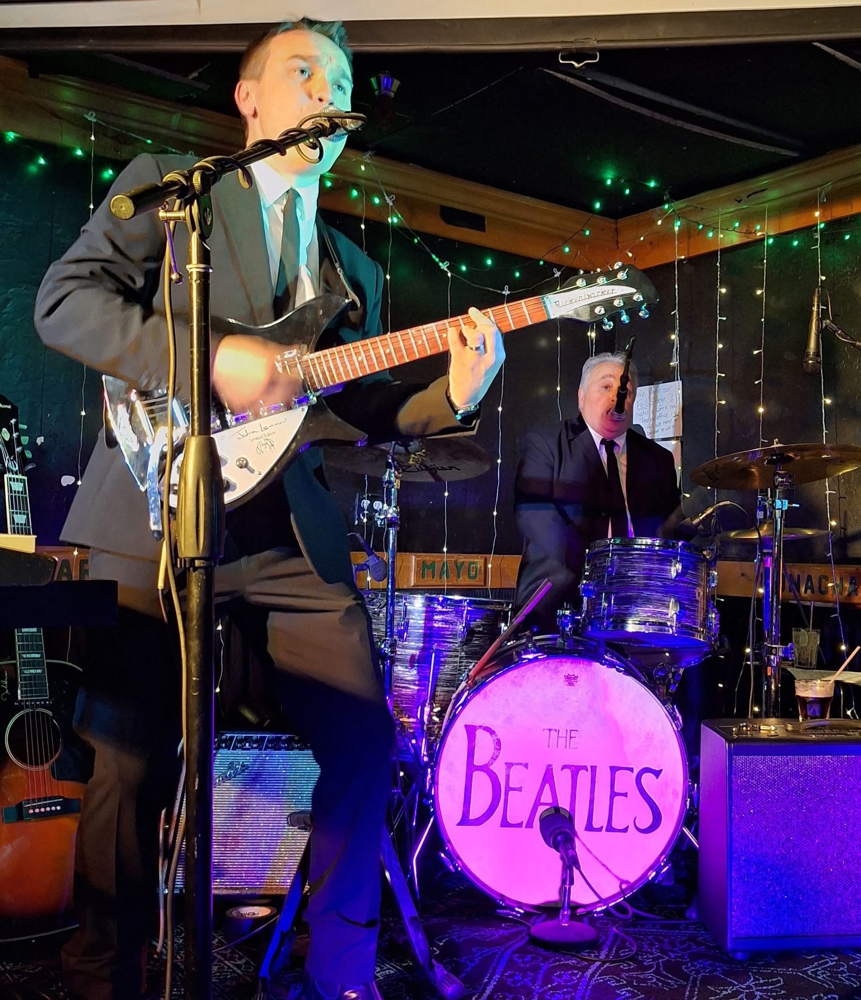 Boots & Suits on stage with guitars